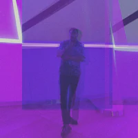 a man wearing a black t - shirt and jeans